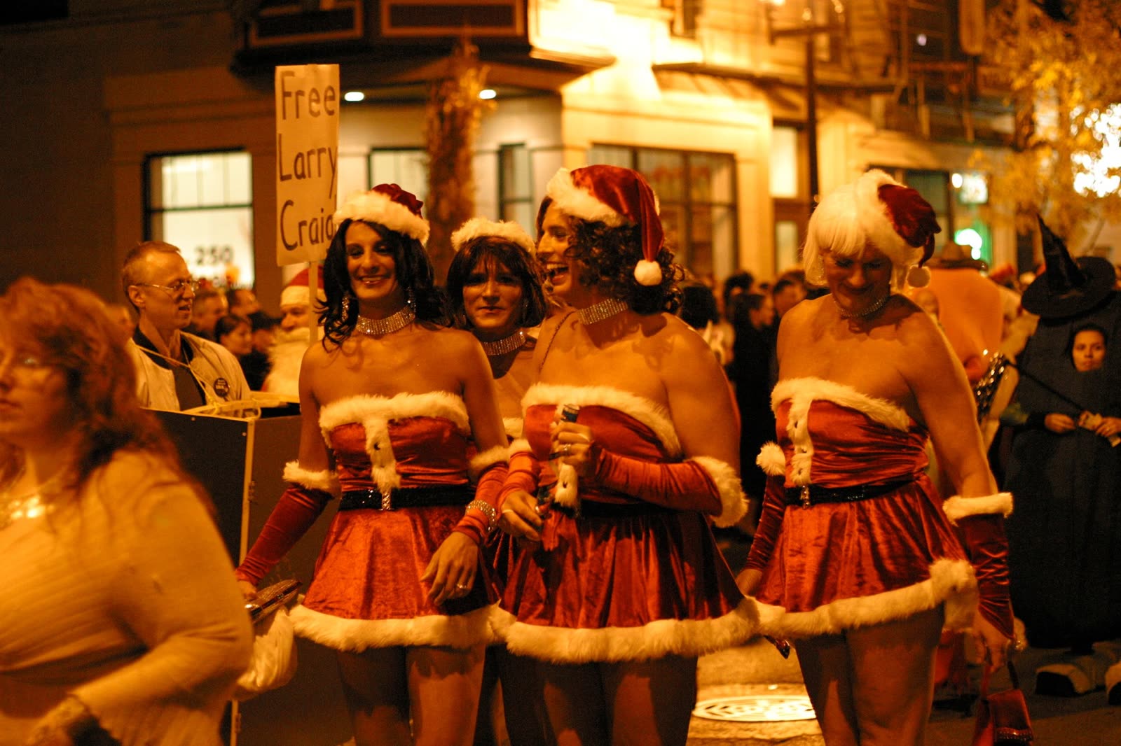 Three women dressed as Mrs. Claus in a Halloween crowd in Chicago at night