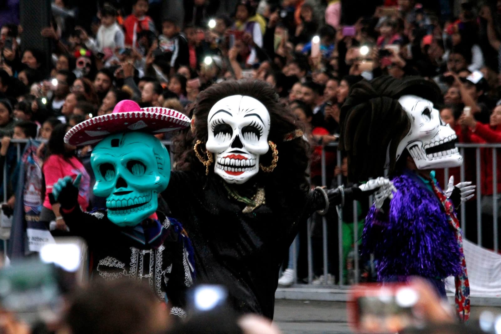 Giant skull-faced figures in Mexico City's Day of the Dead parade